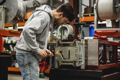 Gutter machine manufacturing technician working on the assembly of a new KWM Gutterman gutter machine